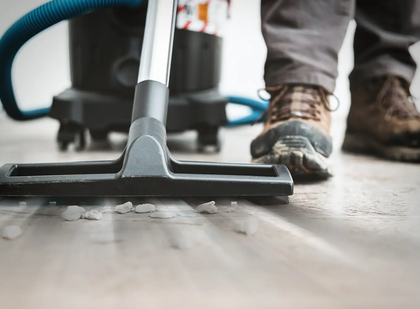 a person vacuuming up rocks - post-construction cleaning services near collinsville il